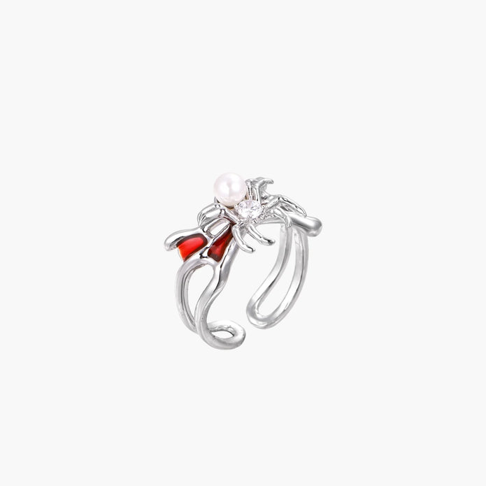 White gold plated spider ring with pearl body, clear zirconia center, and red enamel leg accents on adjustable band