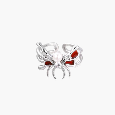 White gold plated spider ring with pearl body, clear zirconia center, and red enamel leg accents on adjustable band