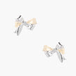 Dimensional bow stud earrings in white gold plated brass with silver and cream two-tone finish on neutral background
