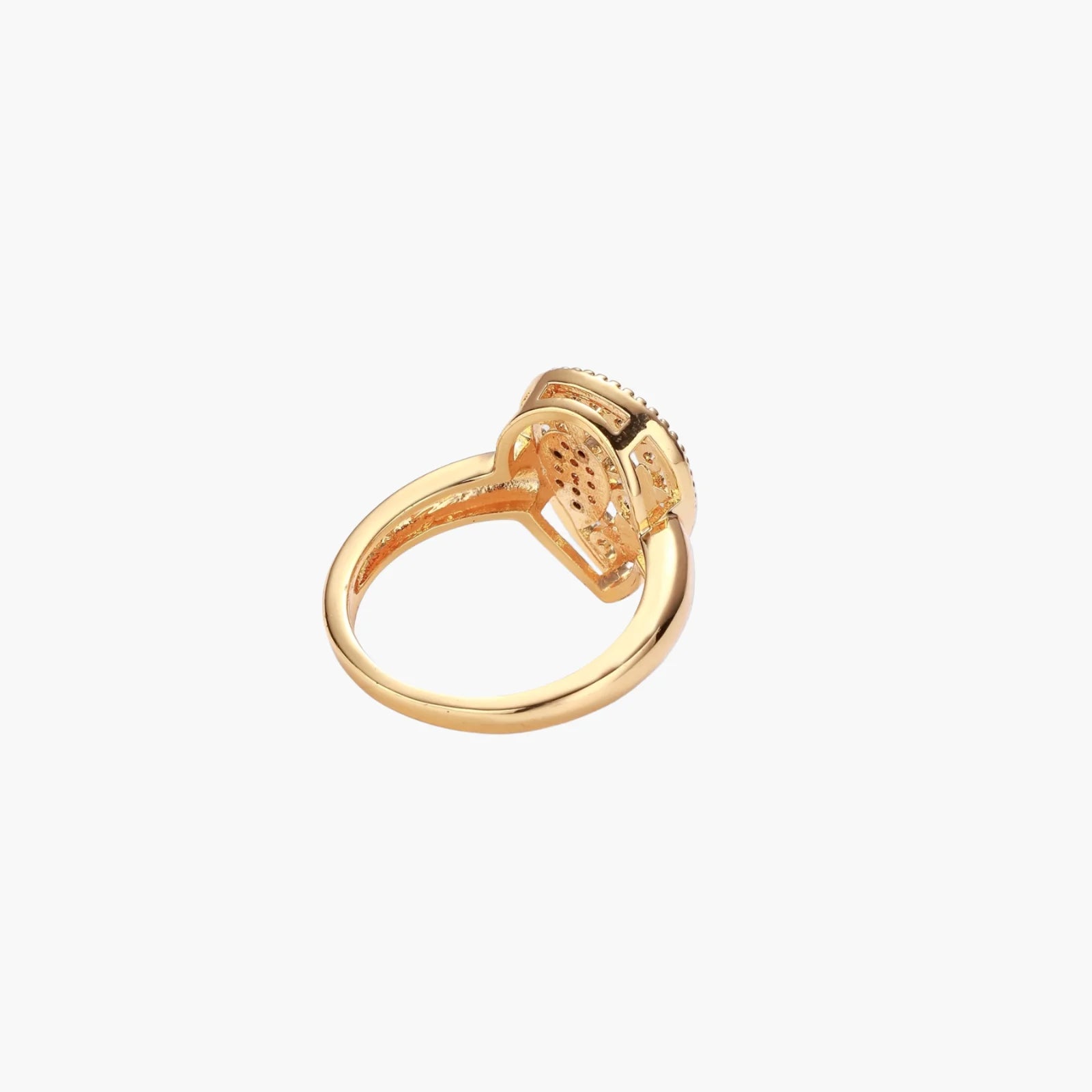 Teardrop-shaped gold-plated ring with turquoise enamel flowers and crystal pavé detail on cream background