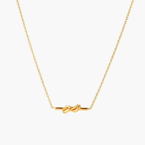 Dainty 18K gold plated necklace with infinity knot pendant on delicate chain against white background