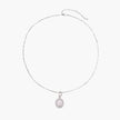 Oval sterling silver pendant with crystal halo surrounding a white freshwater pearl on delicate chain