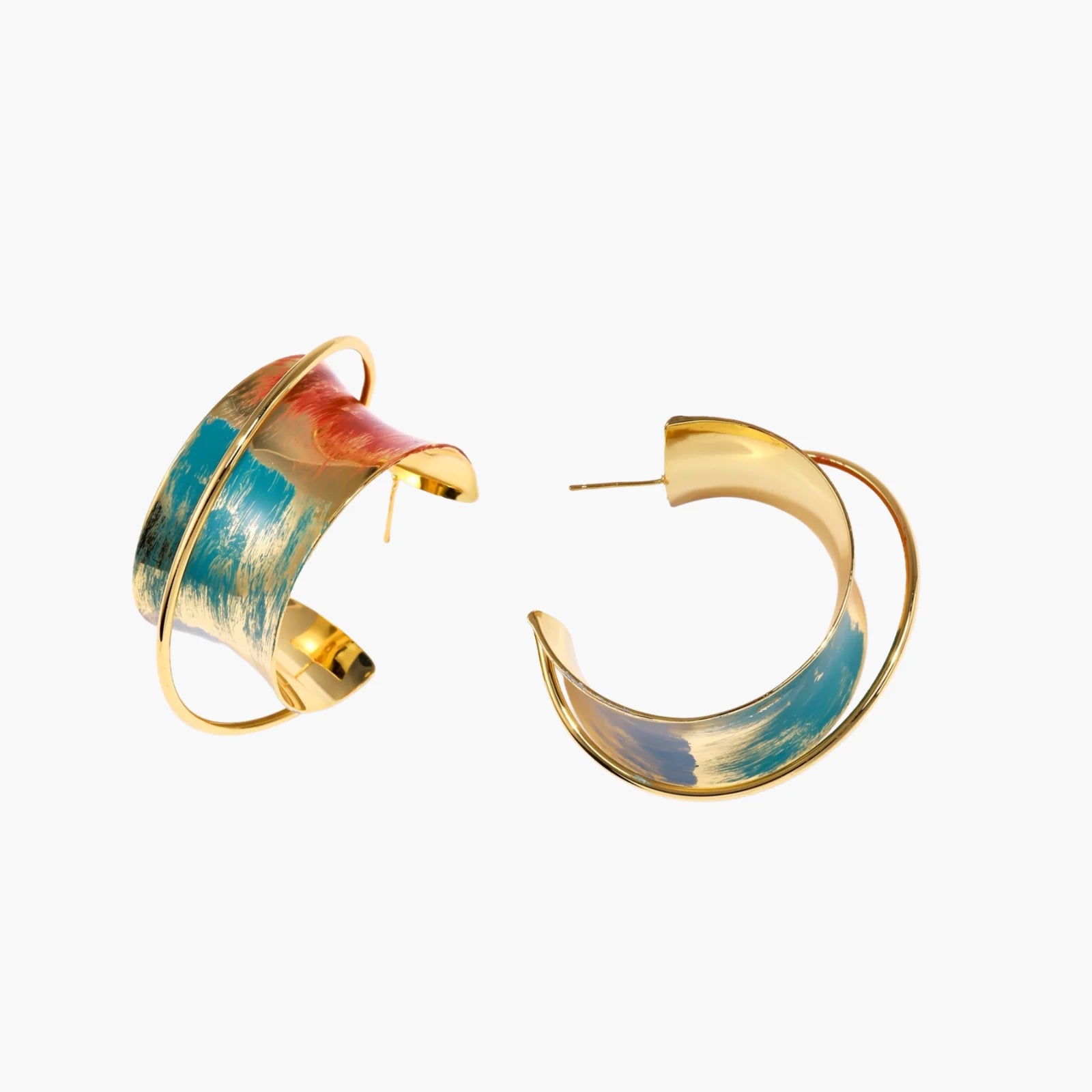 Gold-plated hoop earrings with teal and coral enamel brushstroke design on cream background