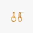 Gold stud earrings with vertical ridged bar connecting to triple interlocking circular rings on white background