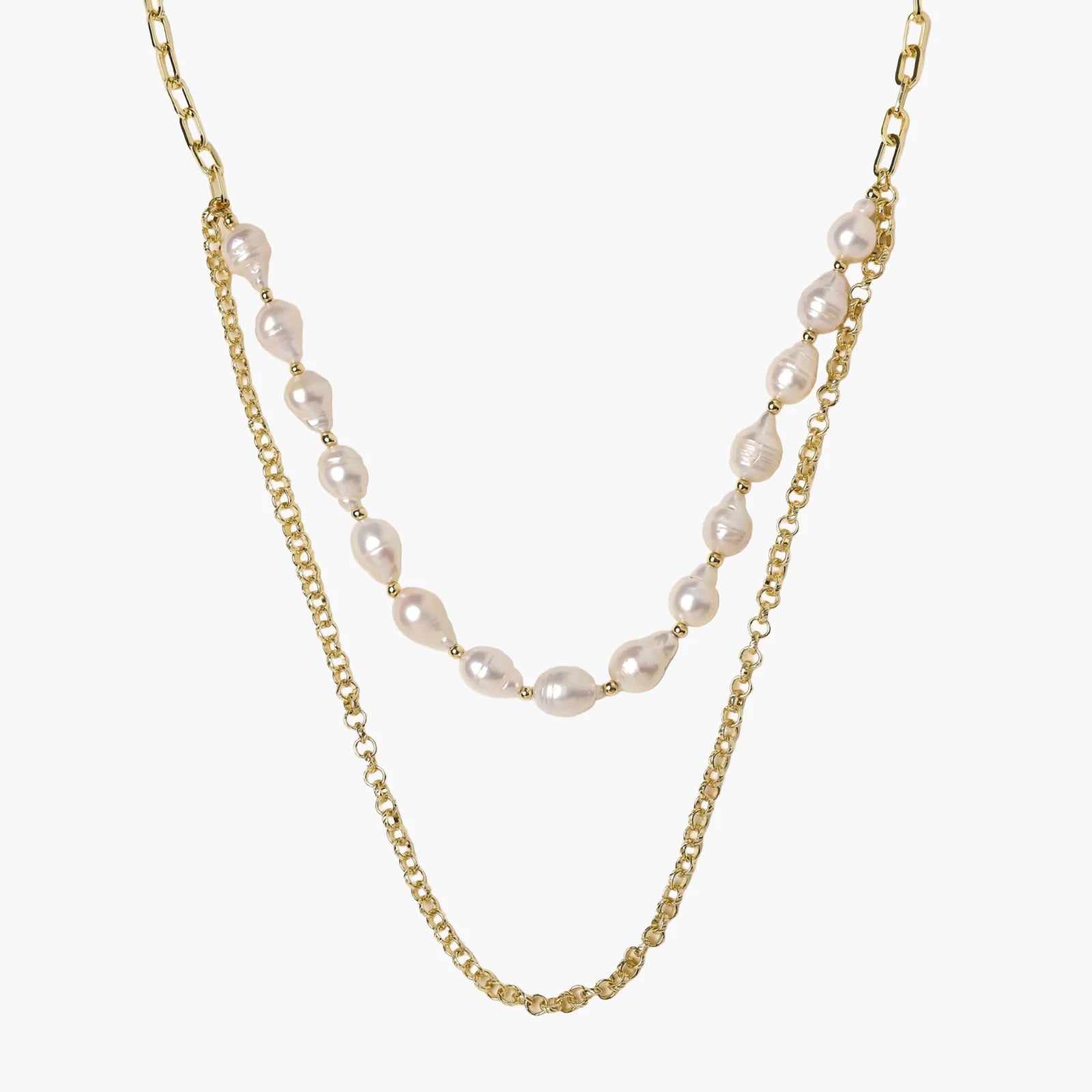 Layered gold chain necklace with organic baroque freshwater pearls and adjustable length on cream background