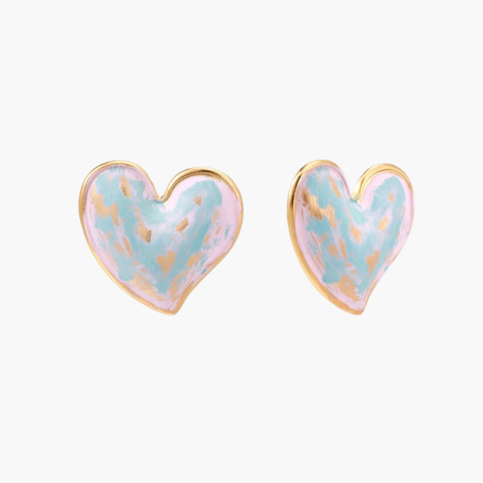 Heart-shaped stud earrings with swirled turquoise and pink enamel in gold-plated frames on cream background