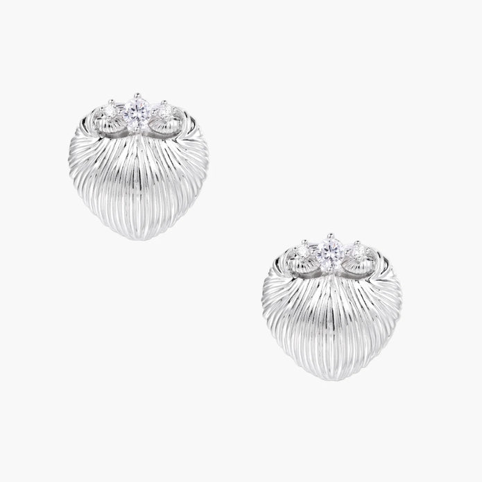 White gold-plated shell-textured stud earrings with three zirconia crystals on ridged surface against cream background.