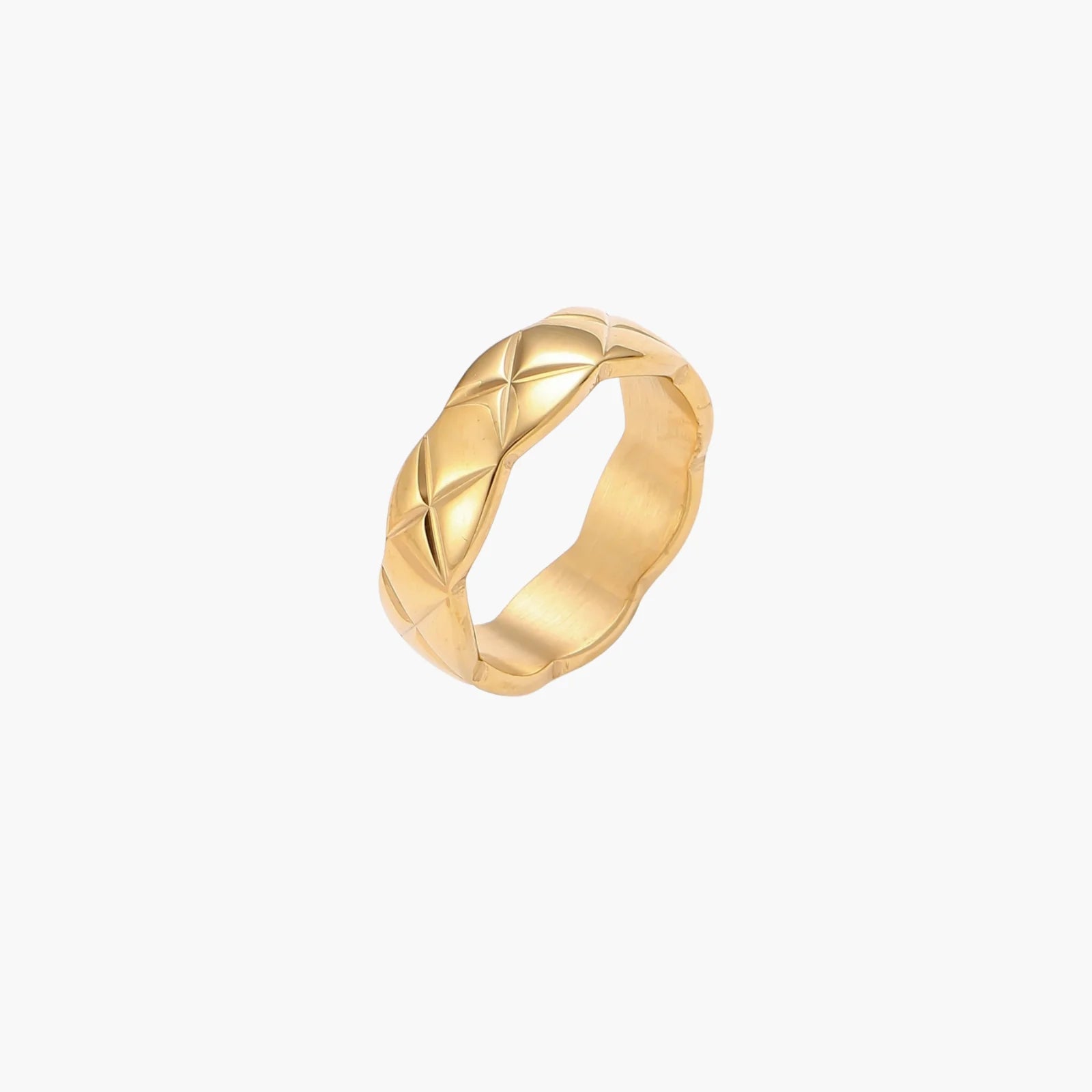 Close-up of an 18K gold-plated twisted band ring with dimensional braided pattern on cream background.