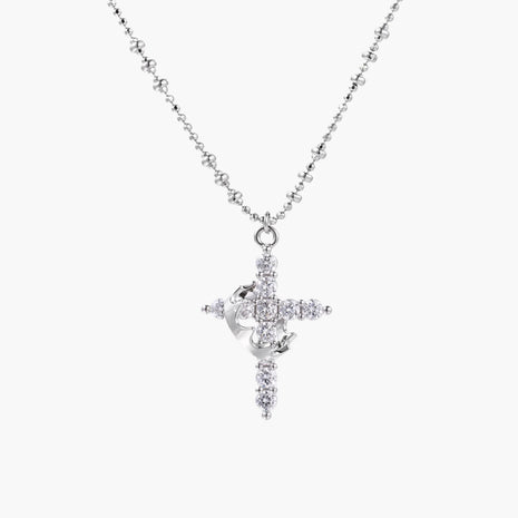 White gold-plated cross pendant adorned with sparkling zirconia stones and crescent moon accent on ball chain