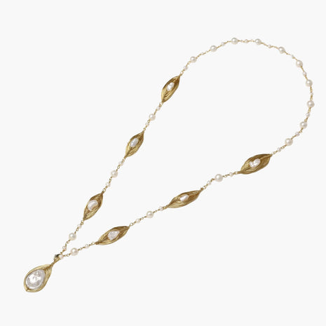 14K gold-plated necklace with eye-shaped stations and baroque pearl pendant on cream background
