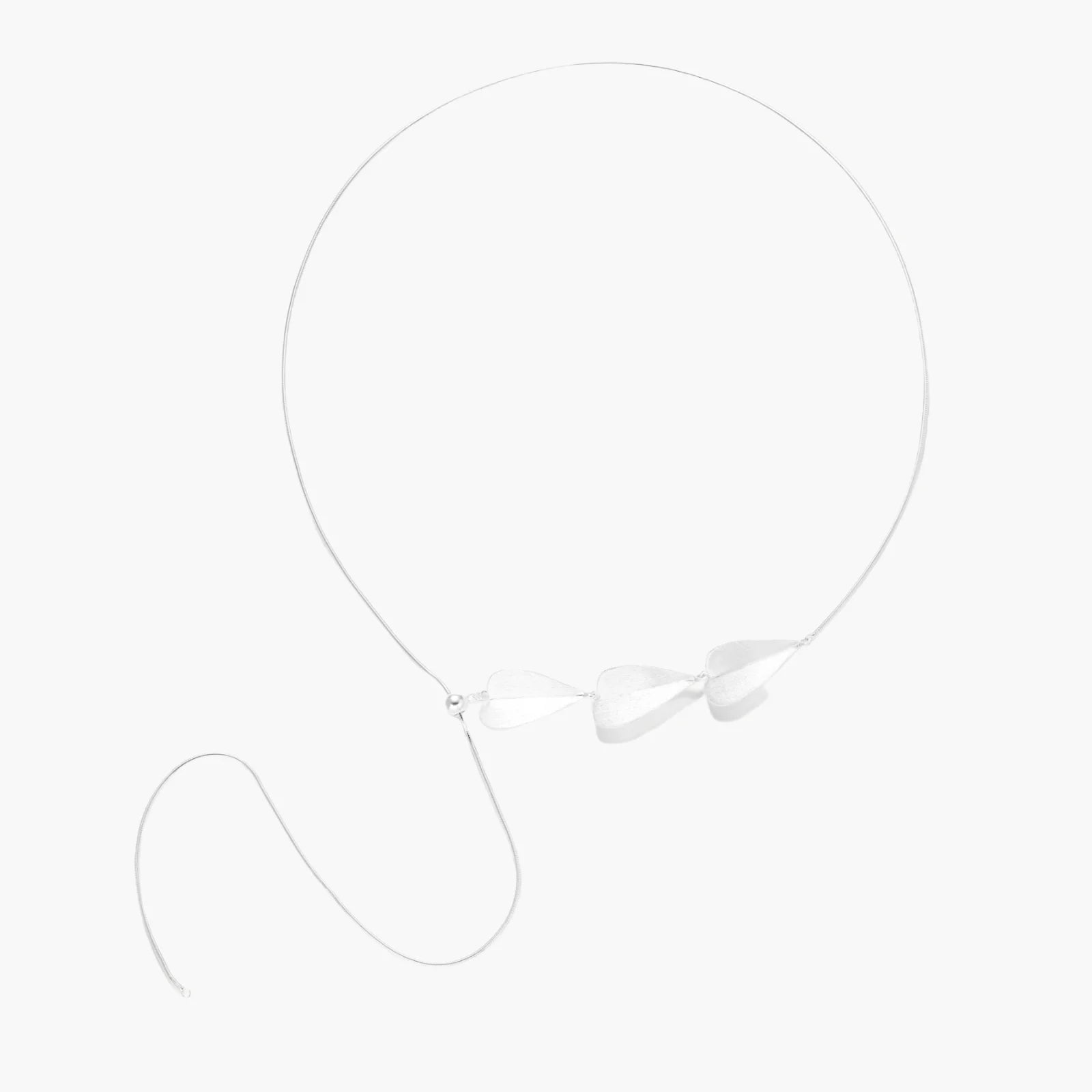 Minimalist sterling silver necklace with three brushed leaf-shaped pendants on delicate chain against white background
