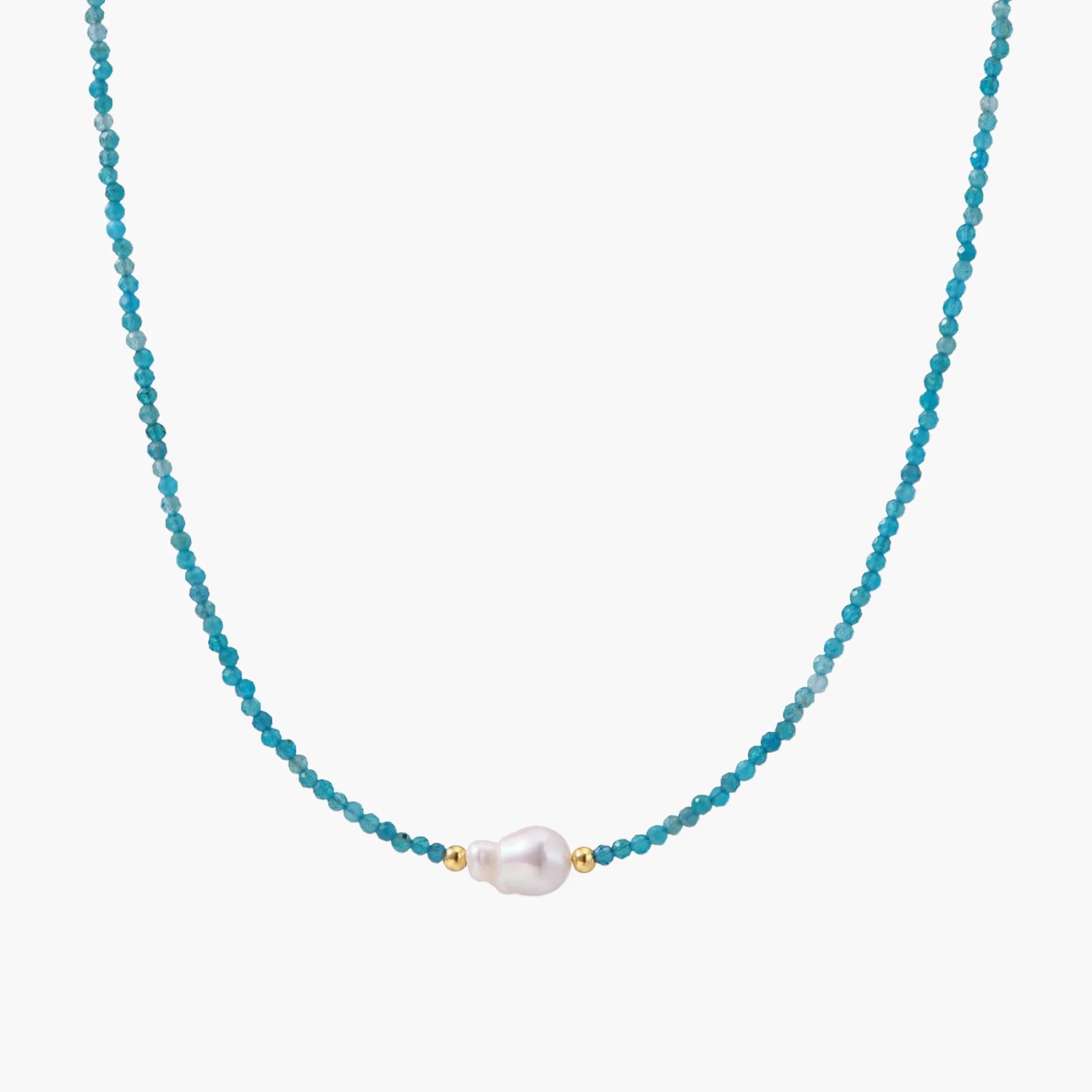 Delicate gold vermeil necklace with teal apatite beads and freshwater pearl on white background.