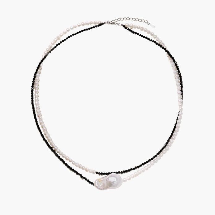 Double-strand necklace with black faceted quartz and white pearls featuring an oversized baroque pearl centerpiece