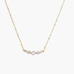 Delicate 14K gold-plated necklace with five graduated zirconia stones arranged in a curved arc on fine chain