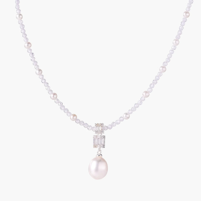 Dainty necklace with lavender crystal beads, freshwater pearls, geometric pendant, and large pearl drop on white background.