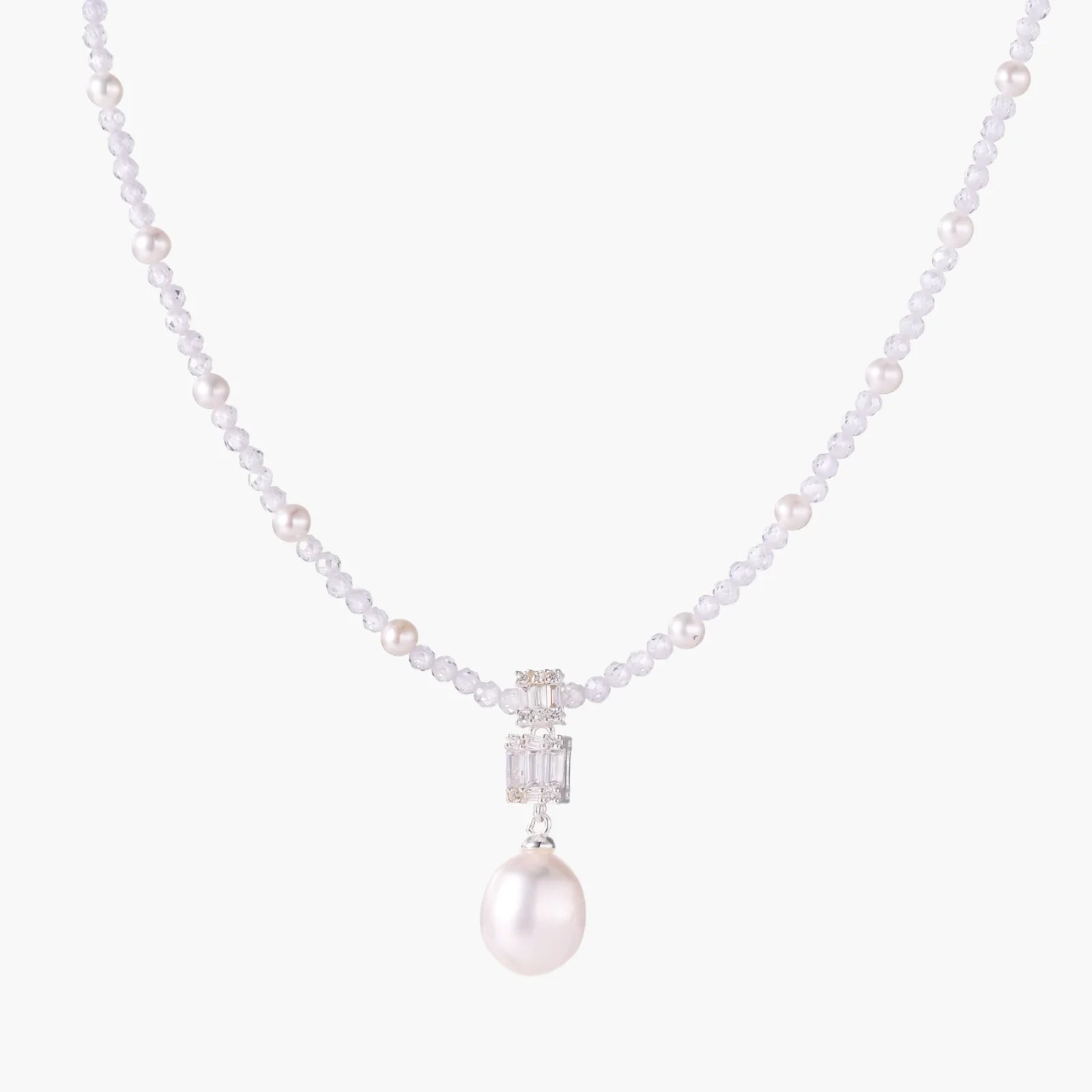 Dainty necklace with lavender crystal beads, freshwater pearls, geometric pendant, and large pearl drop on white background.