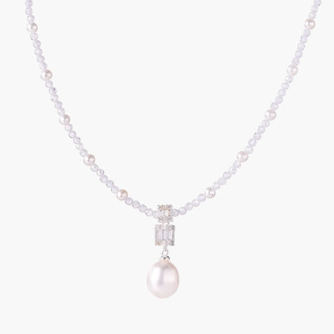Dainty necklace with lavender crystal beads, freshwater pearls, geometric pendant, and large pearl drop on white background.