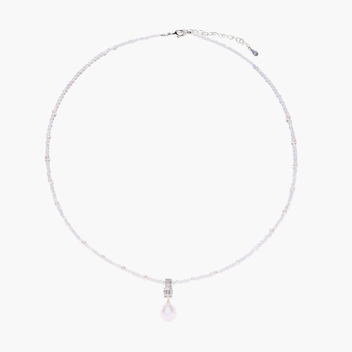 Dainty necklace with lavender crystal beads, freshwater pearls, geometric pendant, and large pearl drop on white background.