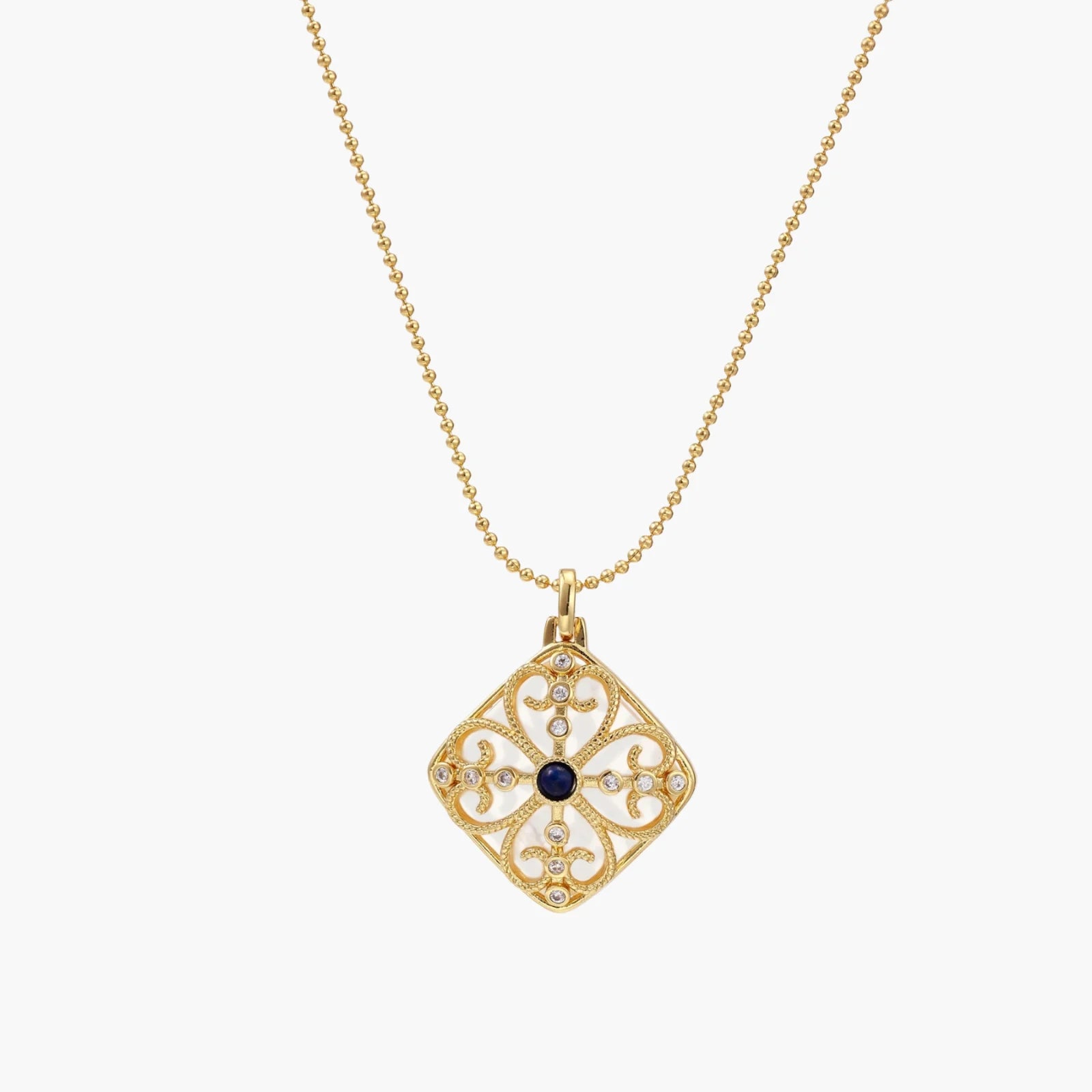 Gold filigree pendant with quatrefoil design, deep blue lapis lazuli center, clear crystal accents on ball chain