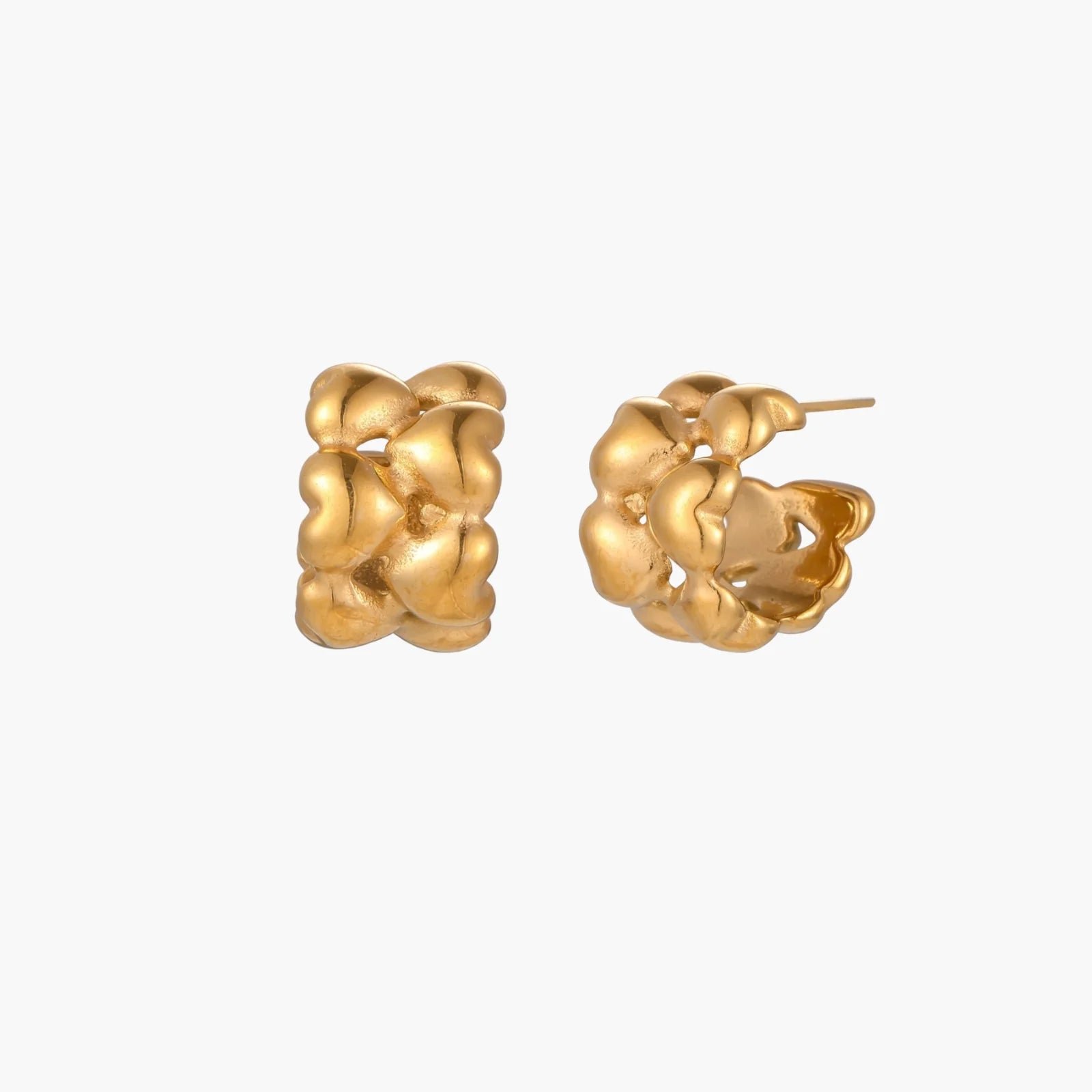 Close-up of gold-plated twisted rope huggie hoop earrings with brushed finish on white background.