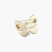 Gold-plated butterfly brooch with iridescent abalone shell wings and freshwater pearl accent on cream background.