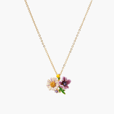 Gold-plated necklace with pink and purple enamel flower pendant featuring crystal accents on cream background
