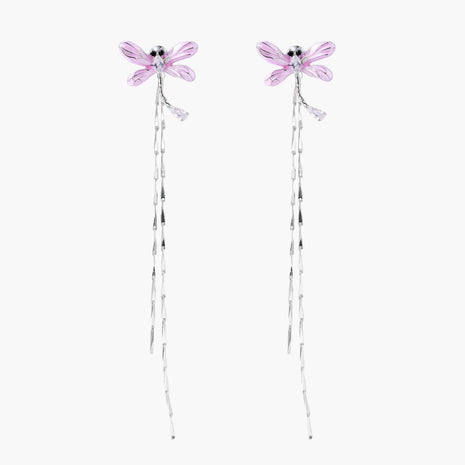 Long drop earrings with translucent lavender enamel dragonfly wings and white gold plated segmented bodies on white background