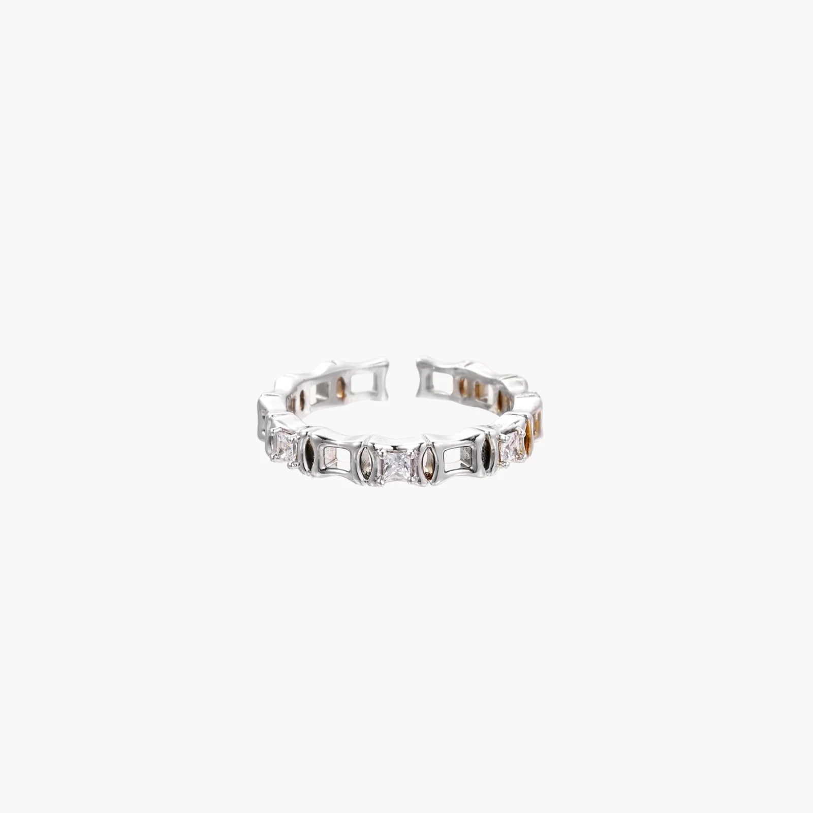 White gold plated ring with architectural lattice design and zirconia accents on cream background