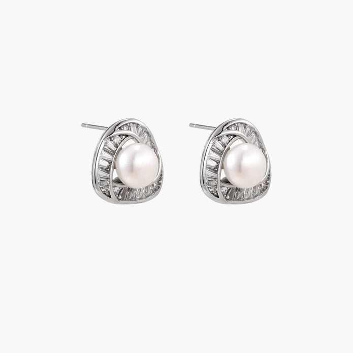 Triangular white gold plated stud earrings with central freshwater pearl and baguette-cut stones on white background