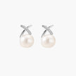 Rhodium-plated silver stud earrings with sparkling X design above lustrous round freshwater pearls on white background.
