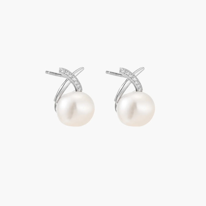 Rhodium-plated silver stud earrings with sparkling X design above lustrous round freshwater pearls on white background.