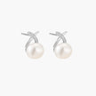 Rhodium-plated silver stud earrings with sparkling X design above lustrous round freshwater pearls on white background.