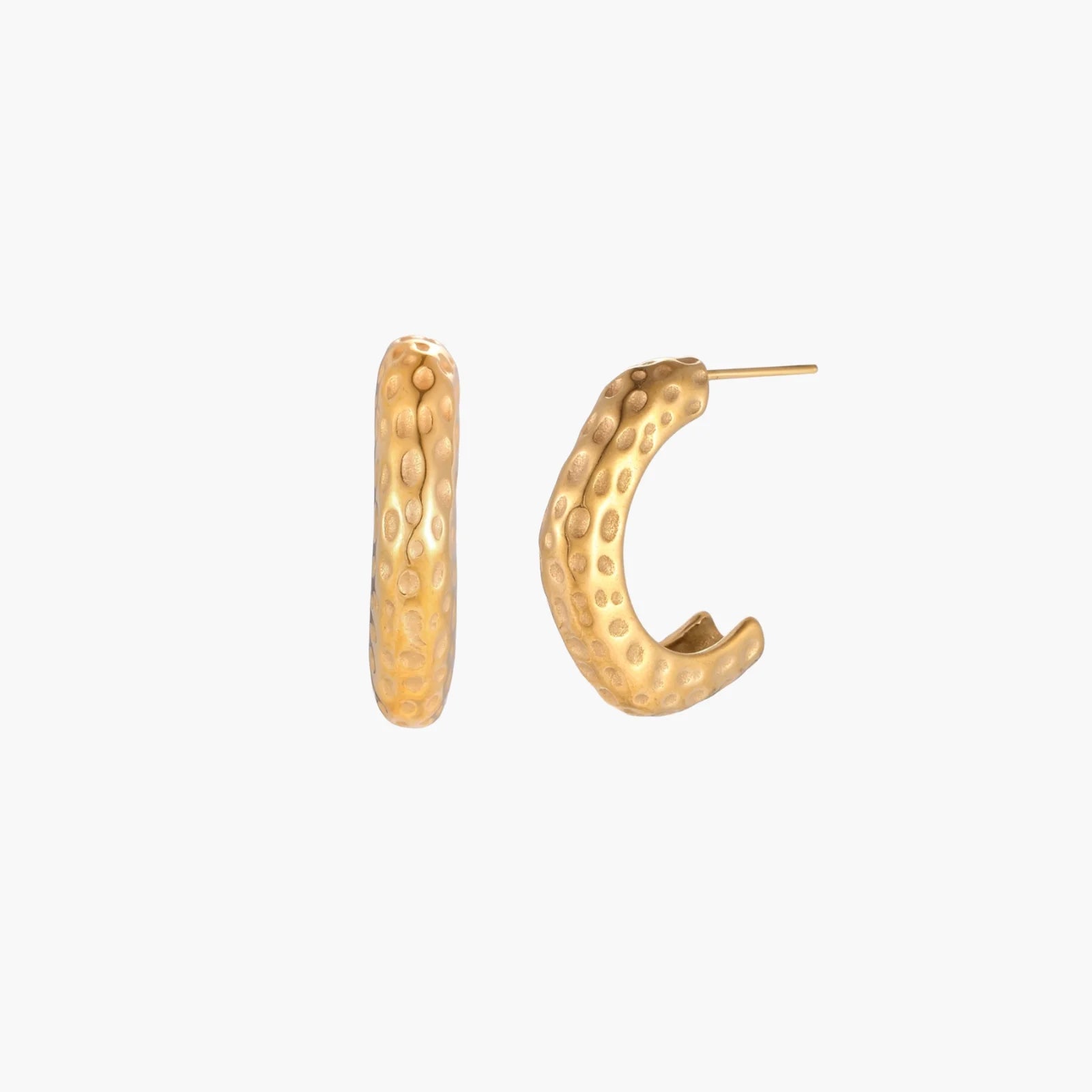 Gold-toned hoop earrings with hammered dimpled texture and post closure on cream background