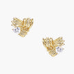 Pair of sculptural gold-plated wing stud earrings with zirconia stones on cream background, showing dimensional feather design