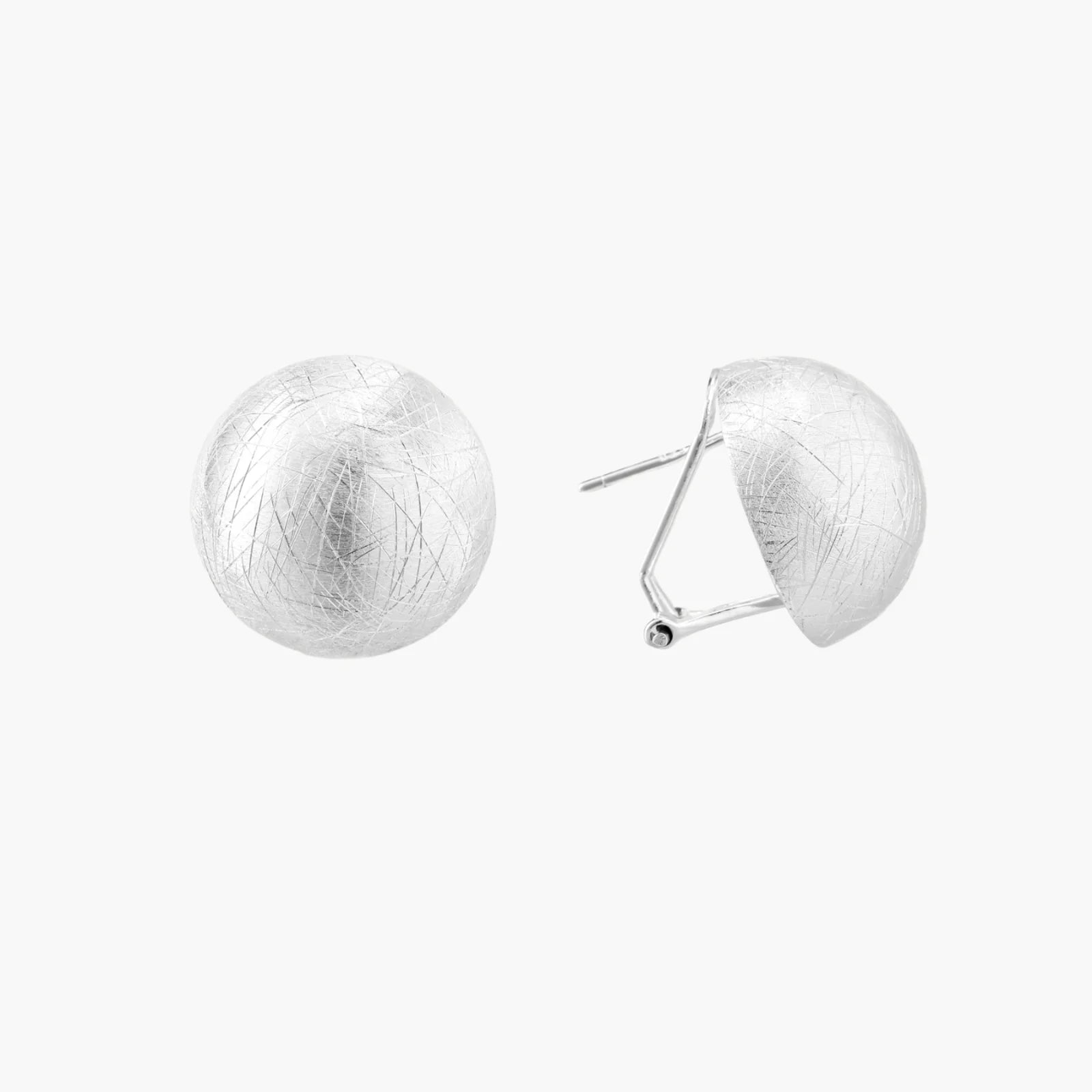 Brushed sterling silver half-dome clip-on earrings with textured surface against cream background