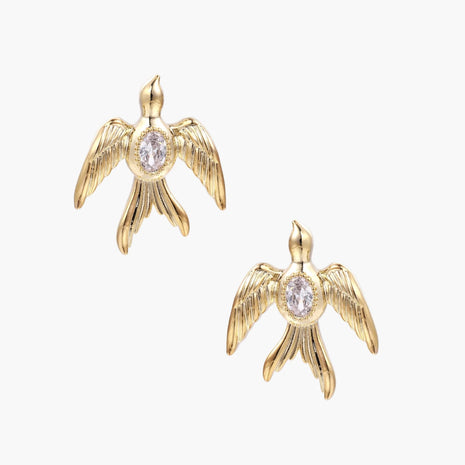 Gold-plated brass earrings shaped as doves in flight with lavender zirconia oval stones at center and textured wing details