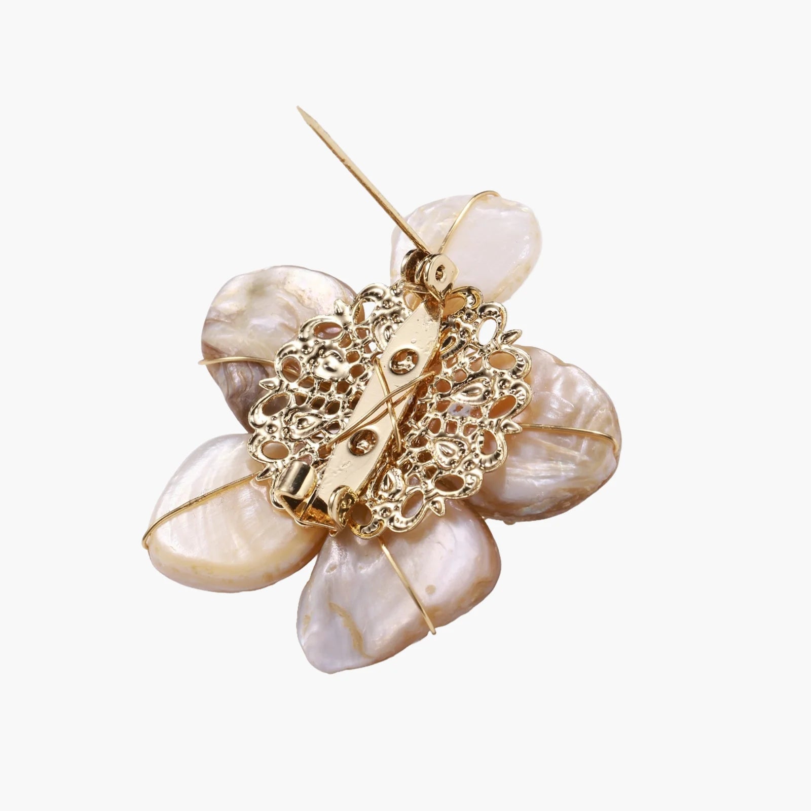 Flower-shaped brooch with iridescent shell petals, freshwater pearl center, and gold-plated radiating details.