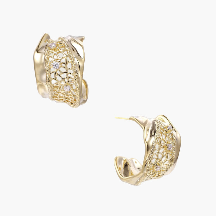 Gold-plated sculptural hoop earrings with geometric lattice centerband and sparkling zirconia on white background.