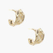Gold-plated sculptural hoop earrings with geometric lattice centerband and sparkling zirconia on white background.