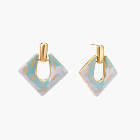 Geometric square enamel earrings with marbled turquoise and lavender pattern, gold U-shaped connector on cream background.