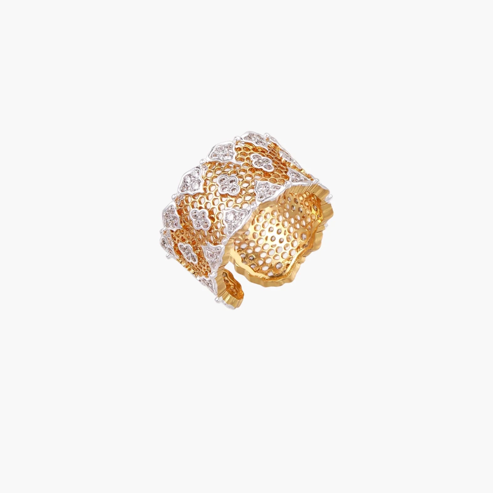 Two-tone gold and silver lattice ring with clover pattern and crystal accents on white background