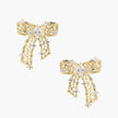 Filigree bow-shaped earrings with marquise center stone and lattice ribbon tails in gold and silver finishes