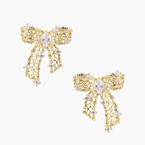 Filigree bow-shaped earrings with marquise center stone and lattice ribbon tails in gold and silver finishes