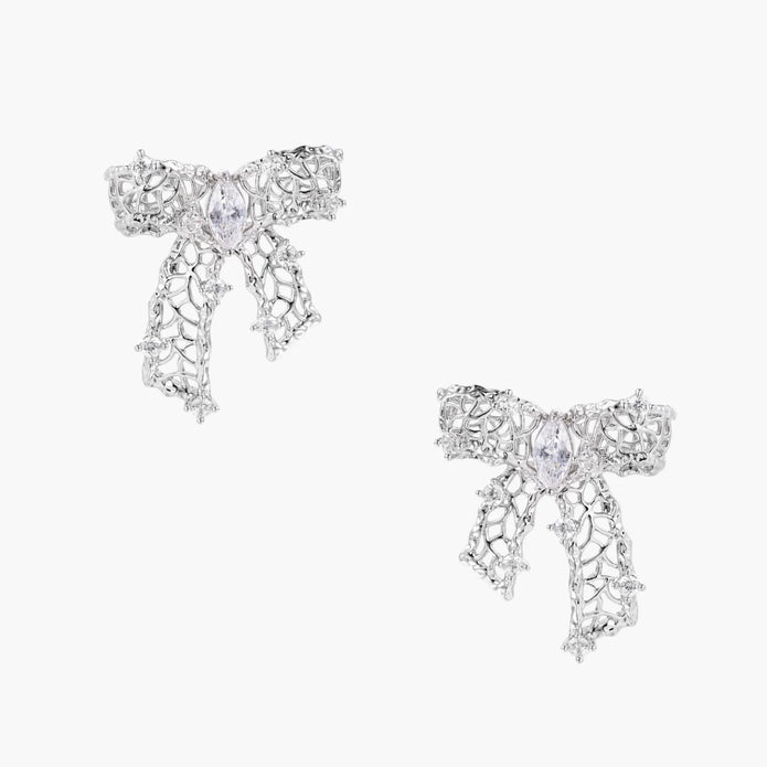 Filigree bow-shaped earrings with marquise center stone and lattice ribbon tails in gold and silver finishes