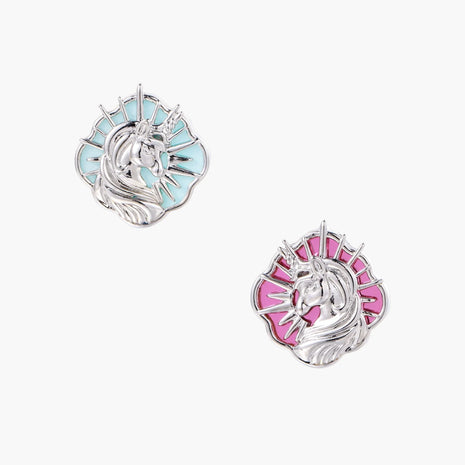 Silver unicorn stud earrings with pastel blue and pink enamel stones in sunburst prong settings on cream background