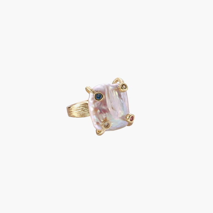 Gold ring with large iridescent baroque pearl and four colored gemstones on textured band