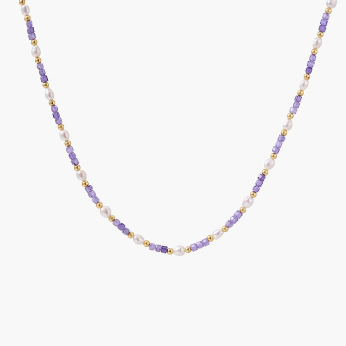 Delicate 18K gold vermeil necklace with alternating lavender zirconia beads and white freshwater pearls on cream background