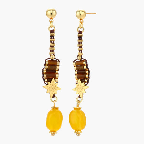 Gold-plated dangle earrings with brown gemstones, star charms, and yellow amber drops on cream background.
