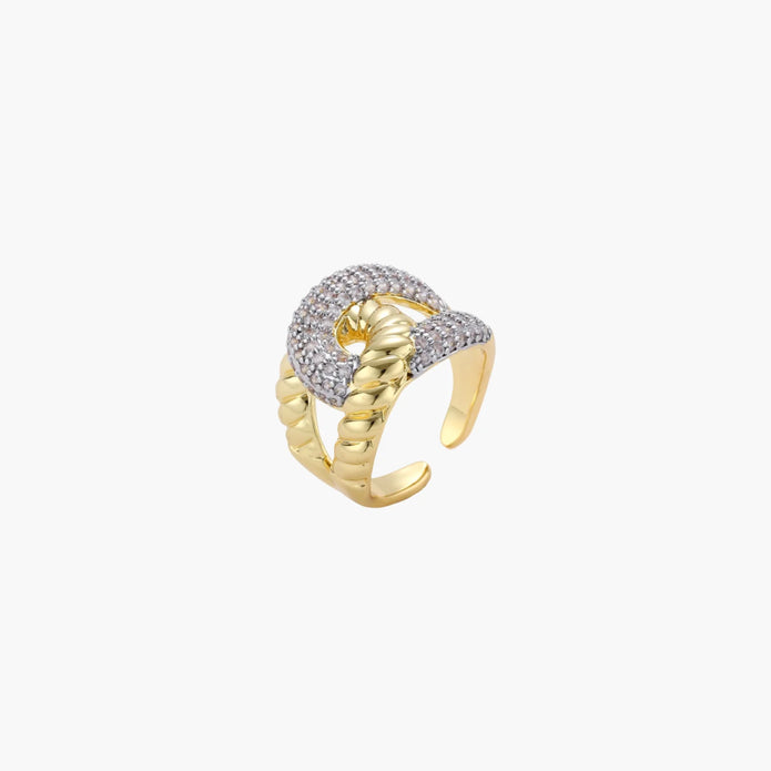 Chunky gold-plated chain-link ring with curved segments and sparkling zirconia crystals on neutral background