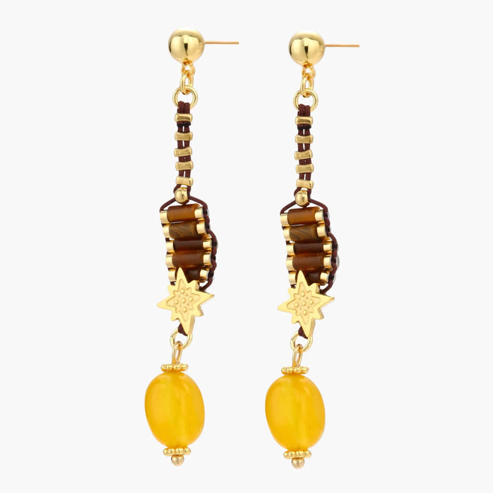 Gold-plated dangle earrings with brown gemstones, star charms, and yellow amber drops on cream background.